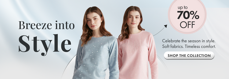 Two women wearing light blue and pink sweaters with a promotional banner about a sale on soft fabrics.